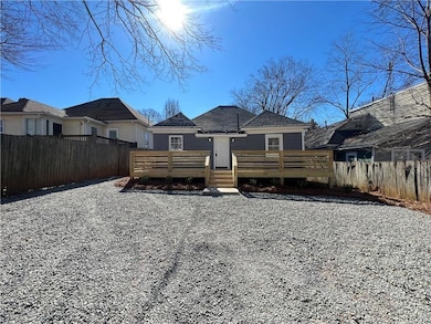 Rear view of property with fence and a wooden deck