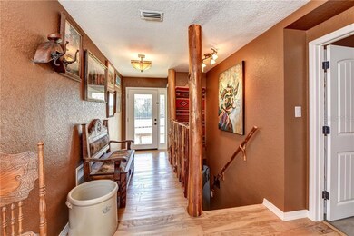 Foyer with decorative staircase and hardwood floor