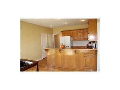 The kitchen has a large counter top for bar seatin