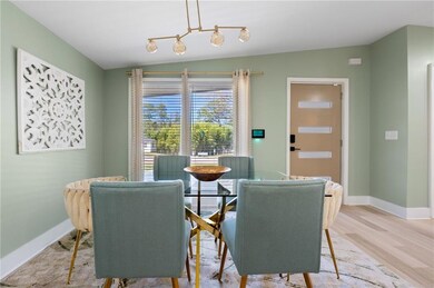 Dining room with baseboards, an inviting chandelie