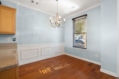 Unfurnished dining area featuring dark wood-type f