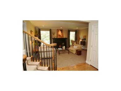 Living room with fireplace and views of the treed 