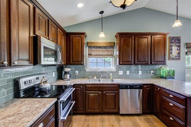Beautiful custom cabinetry, glass subway tile back