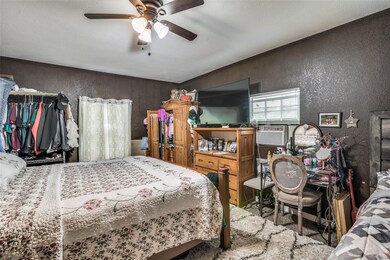 Bedroom featuring cooling unit, a ceiling fan, and