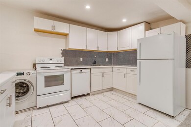 Kitchen featuring white cabinetry, white appliance