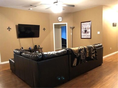 Living room leads to two spare bedrooms, hall bath