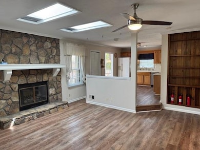 Unfurnished living room featuring crown molding, b