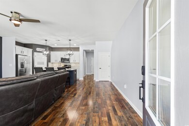 Living room featuring ceiling fan with notable cha