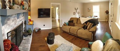 Cuddle up by the wood-burning fireplace on those cold winter evenings.  Living room leads to kitchen. The high-quality laminate wood flooring is allergen free and easy to care for.