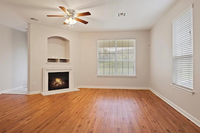 Unfurnished living room featuring wood finished f