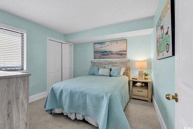 Carpeted bedroom featuring a closet