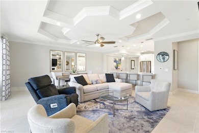 Living area with crown molding, baseboards, coffer