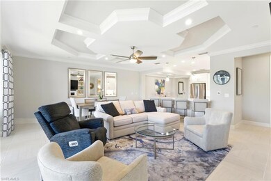 Living area featuring baseboards, ornamental molding, recessed lighting, and ceiling fan