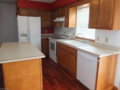 Fully applianced kitchen with island.