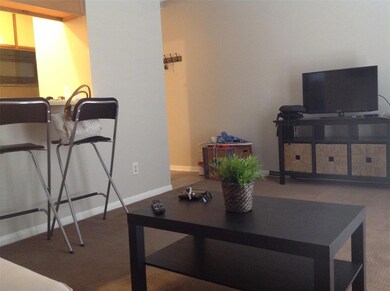 Carpeted living room featuring baseboards