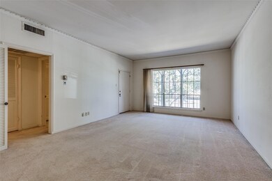 Unfurnished room with light carpet and crown moldi