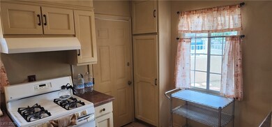 Kitchen featuring white gas stove and under cabine