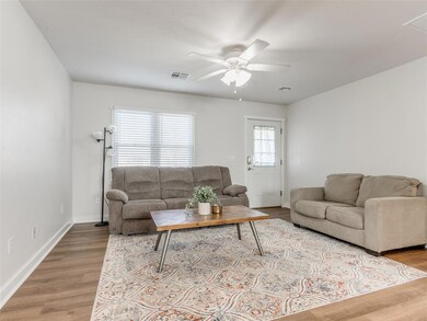 Living room with ceiling fan and wood-type floorin