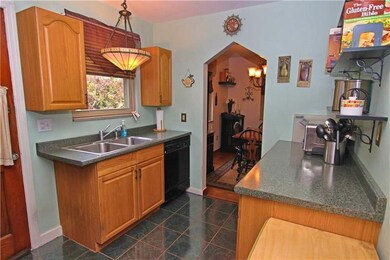 Refrigerator is to the left of the door leading ou