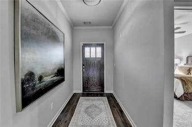 Entryway with ornamental molding, dark wood-type f