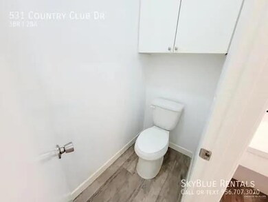 Bathroom featuring hardwood / wood-style floors and toilet
