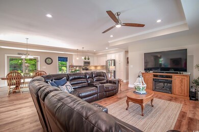 Living room with light wood-type flooring, a raise