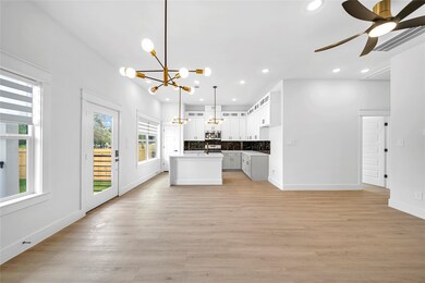 Open-concept space features a modern kitchen with