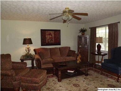 VERY ROOMY LIVING ROOM WITH HARDWOOD FLOORING