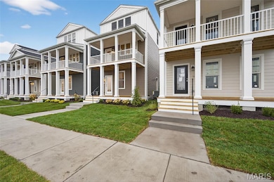 View of front of property with a porch, board and batten siding, and a front yard