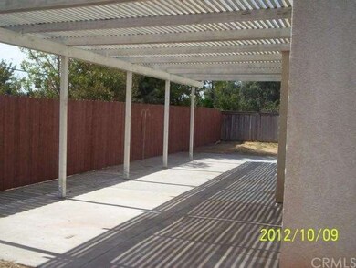 BACK PATIO.SMALL YARD WITH SLOPE BEHIND FENCE