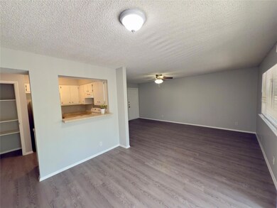 Unfurnished living room featuring a ceiling fan, 