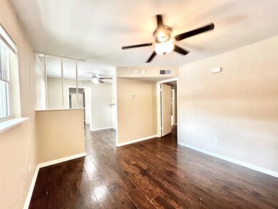 Unfurnished room with ceiling fan, dark hardwood /