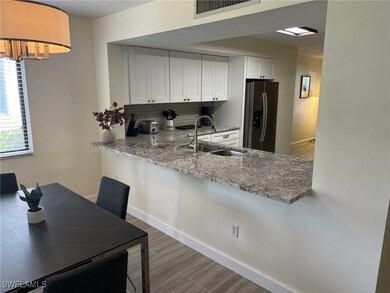 Kitchen with white cabinetry, sink, stainless stee