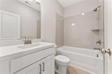 Full bathroom with vanity, bathing tub / shower combination, and tile patterned flooring