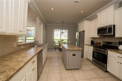Stainless steel appliances and sink. Cute and func