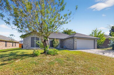 Ranch-style home with brick siding, a front yard,