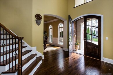 Solid wooden doors leading from covered front porc