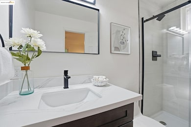 Bathroom featuring vanity and a stall shower