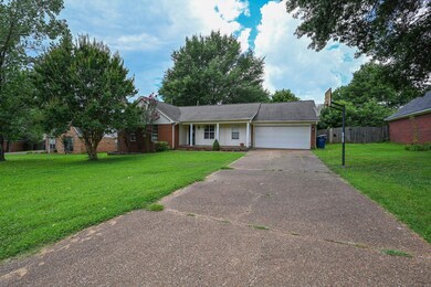 Ranch-style home featuring an attached garage, driveway, and brick siding
