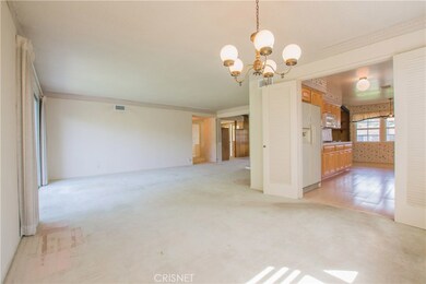 Dining area facing kitchen and den.
