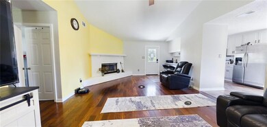 Living room with wood finished floors and a brick fireplace