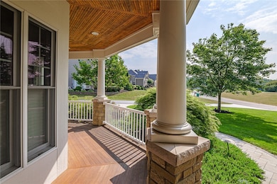 Stunning veranda wraps around the front of the house! Mahogany decking, stone piers and columns with pine beadboard ceilings absolutely charming.