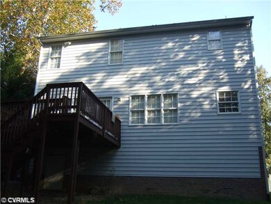 Exterior Back - Large deck over looking a wooded r