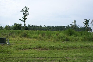 View of lot from road. Grass needs cut.