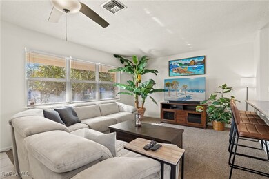 Living room with a textured ceiling, light colored