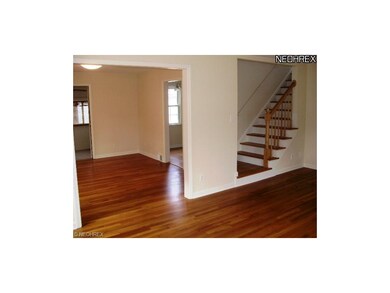 The living room, dining room and the steps upstair