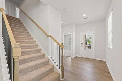 Foyer featuring stairs, wood finished floors, recessed lighting, and baseboards