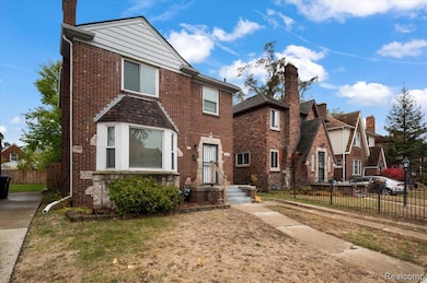 View of front of property with brick siding, a chimney, and a residential view