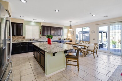 Kitchen with stainless steel fridge, visible vents