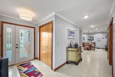 Open foyer has lots of light from the glass door &